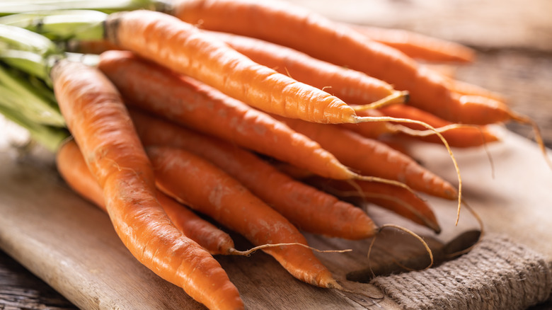 Fresh carrots on cutting board