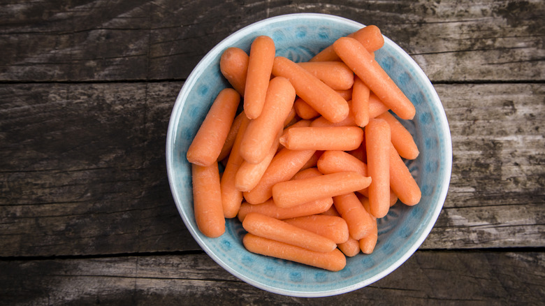 Blue plate of baby carrots