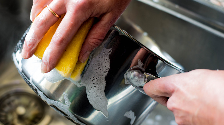 person washing pan