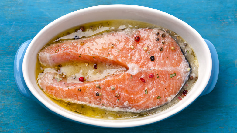 Salmon marinating in oil and spices.