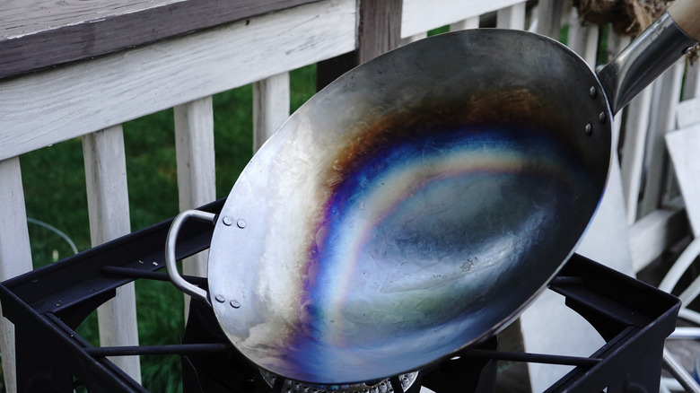 Person seasoning a wok