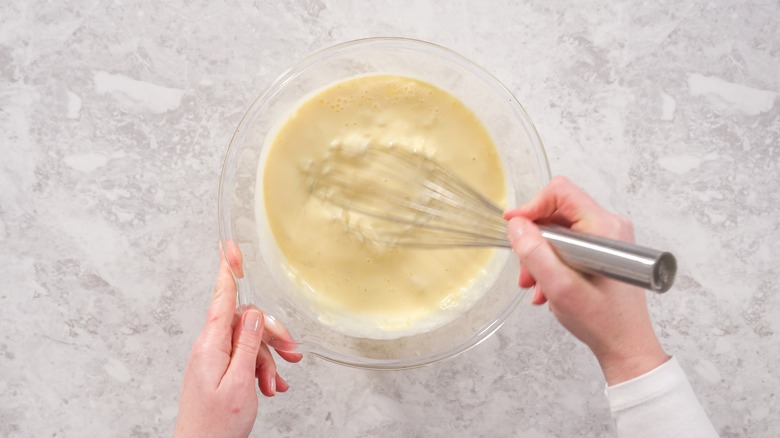 whisking bowl of coconut batter