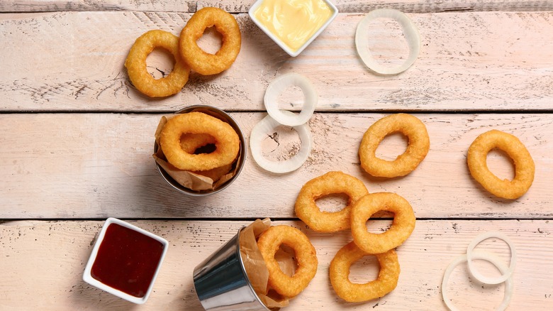 onion rings on table with dipping sauces