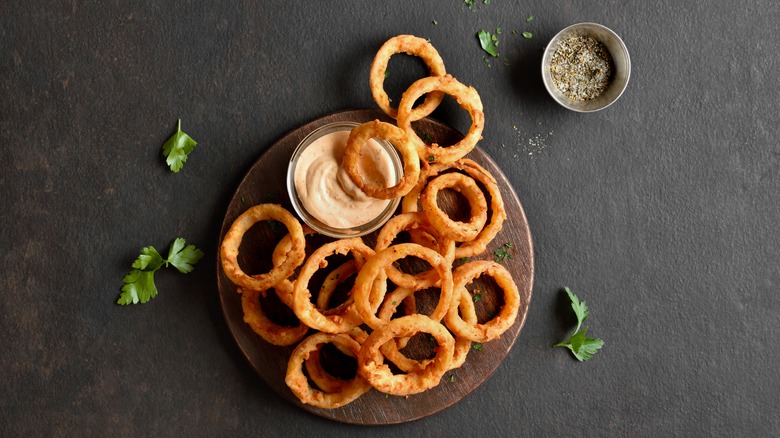 onion rings on black background