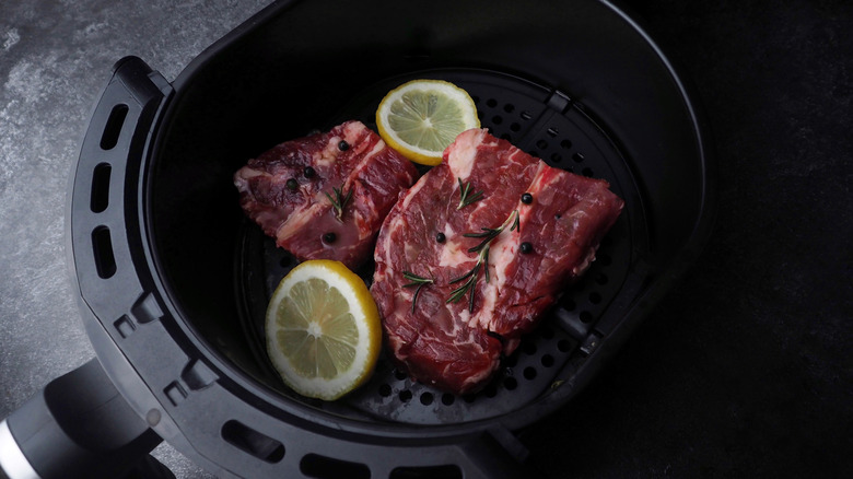 Raw steaks in air fryer