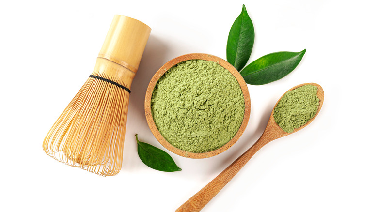 Powdered matcha tea in wood bowl