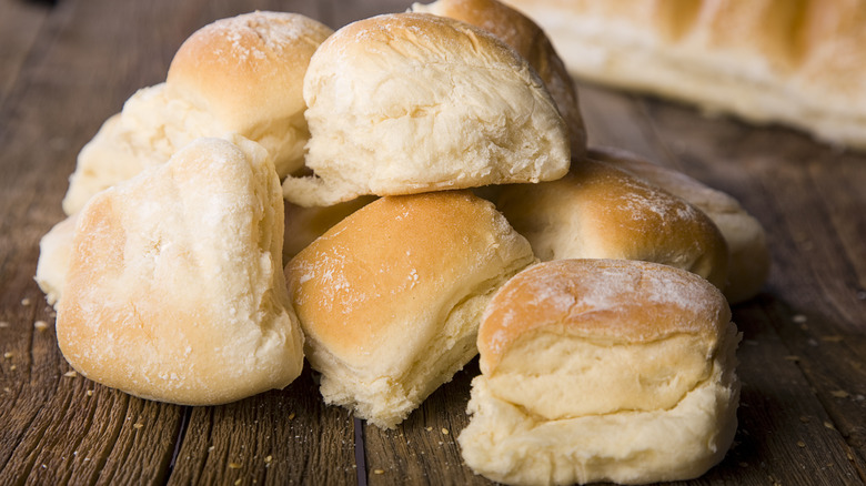 dinner rolls on wooden table