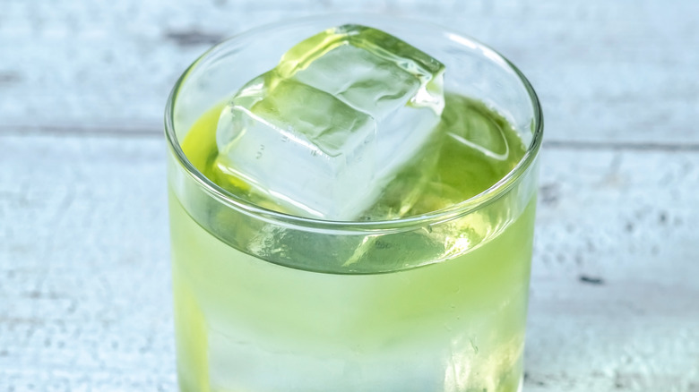 Green cocktail over ice