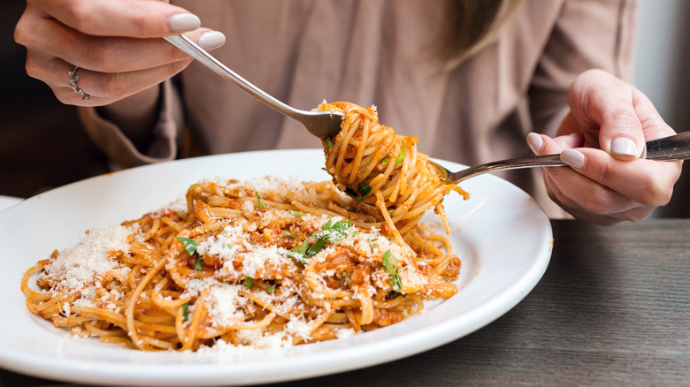 woman twirling spaghetti on a fork