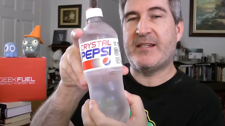 Man holding bottle of Crystal Pepsi