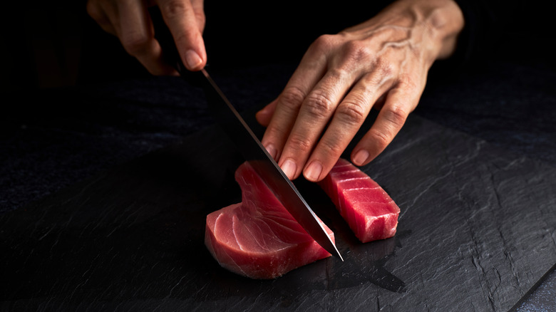 person cutting bluefin tuna