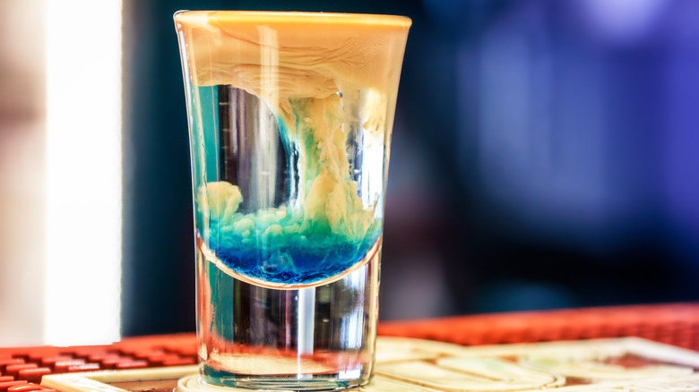 Curdling shot of different colored alcohol