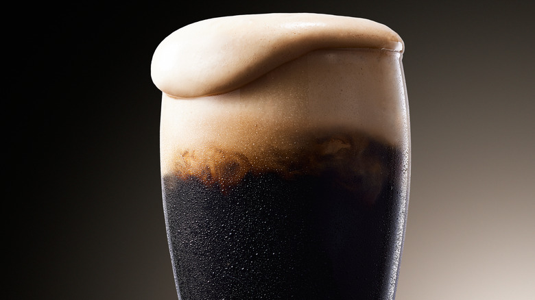 Overflowing glass of irish stout