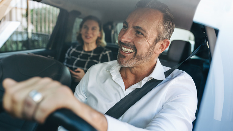 Man, woman talking in car