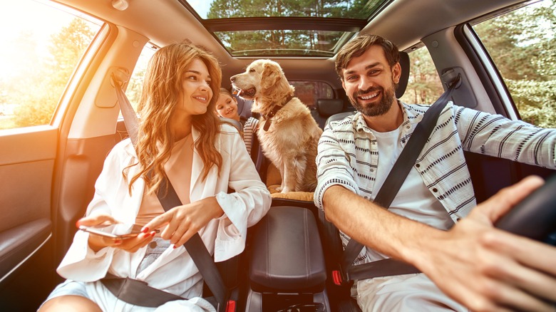 Family in car with dog