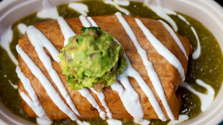 chimichanga in green sauce with guacamole