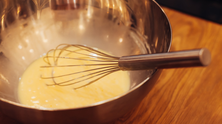 bowl of eggnog with whisk