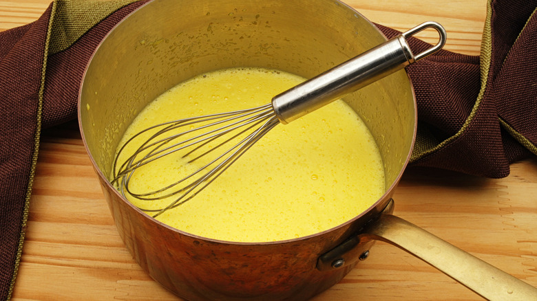 eggnog in pot with whisk