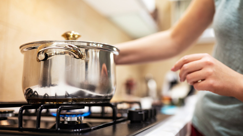 pot over flame on stove