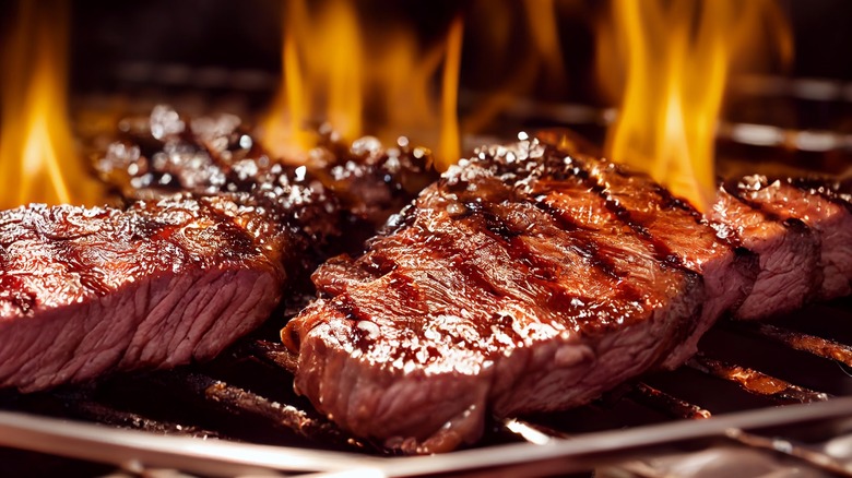 steak being grilled over fire