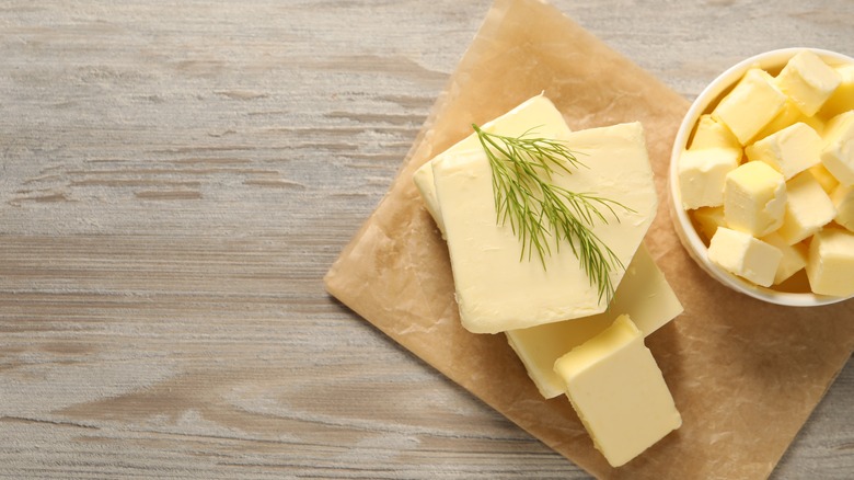 Butter with dill on wooden table