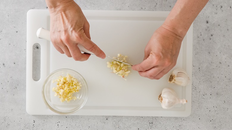 Person chopping garlic