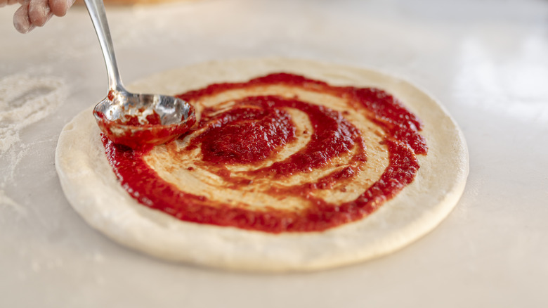 pizza sauce swirled on pizza