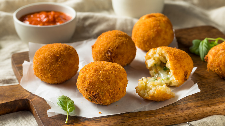 arancini on wooden cutting board