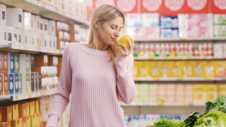 woman smelling bell pepper