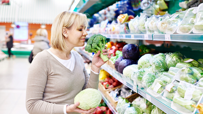 woman sniffing broccoli