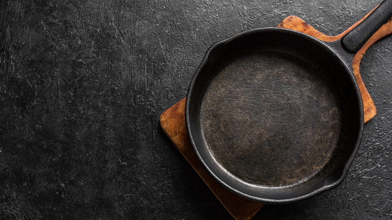 cast-iron skillet on a board