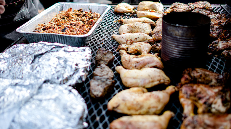 cooking assorted meat at tailgate