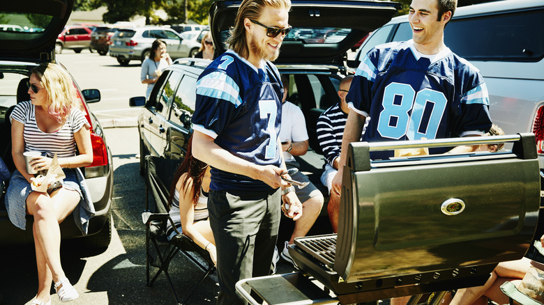 friends cooking at a tailgate