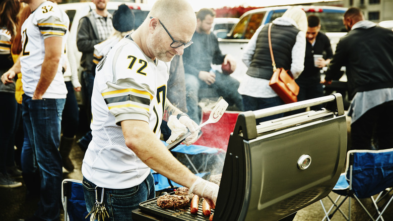 man grilling at tailgating party