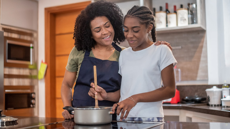 People cooking sauce on stovetop