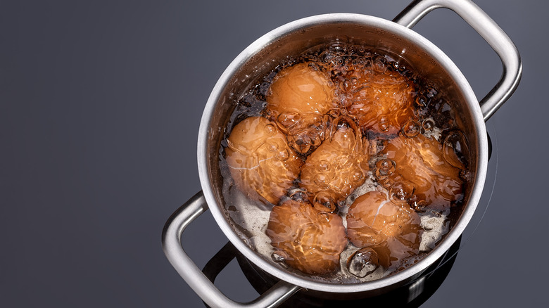 brown eggs in boiling water