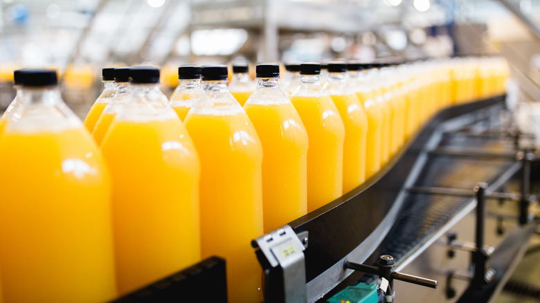 orange juice bottles in factory