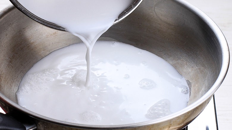 coconut milk pouring into pan