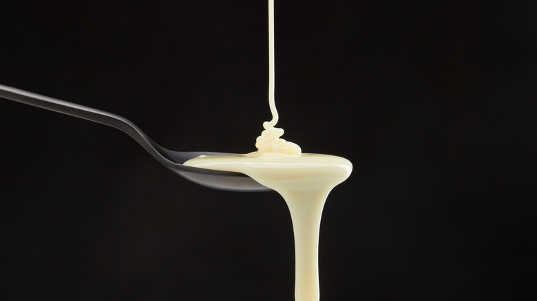 Condensed milk falling onto spoon