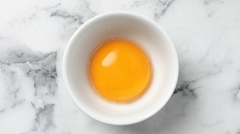 Extra egg yolk in bowl