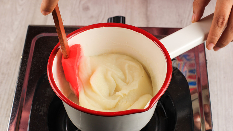 Person making mashed potatoes