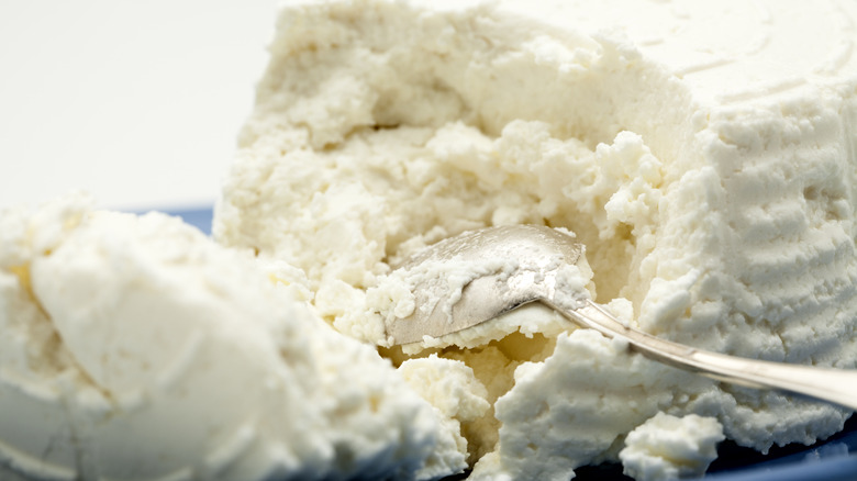 Spoon in block of ricotta