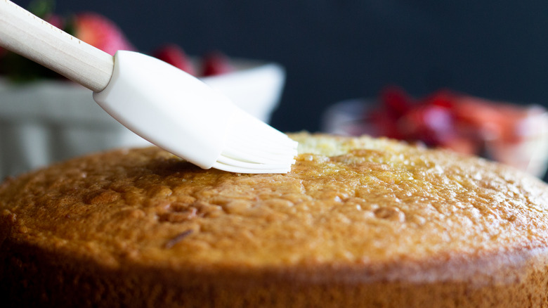 Brushing cake with simple syrup