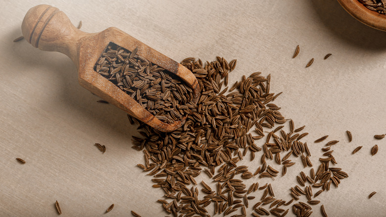 cumin seeds with wooden scoop