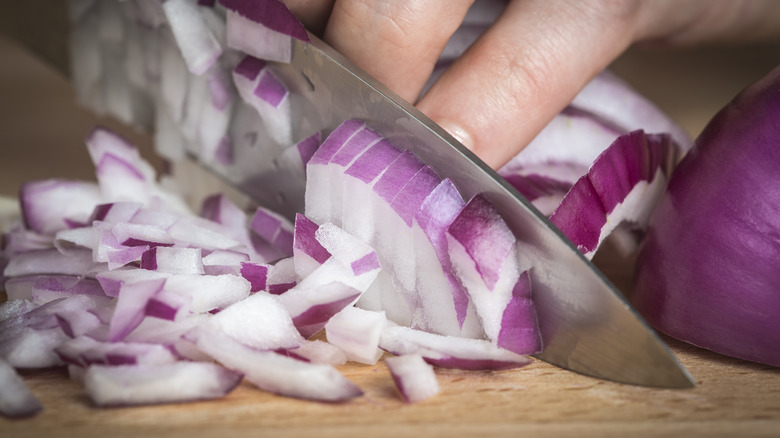 chef chopping red onion