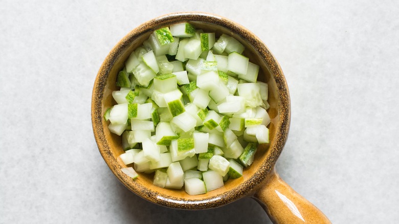 diced cucumbers in ceramic bowl