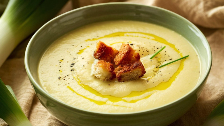 Bowl of potato soup with croutons ana d drizzle of olive oil on top