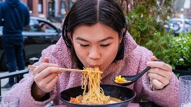 Woman slurping noodles