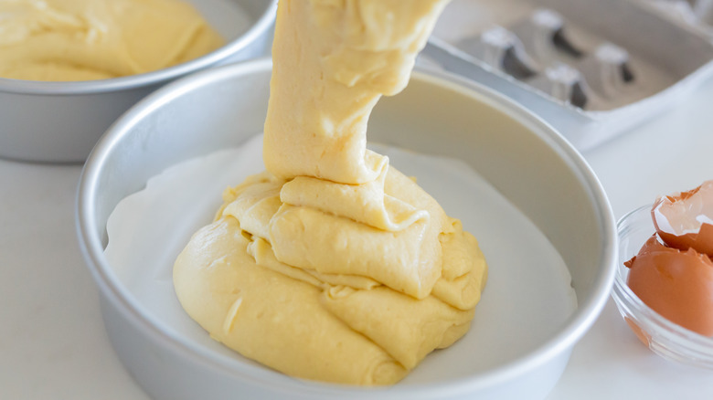 pouring cake batter into pan