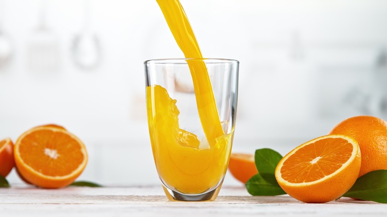 Pouring orange juice into glass